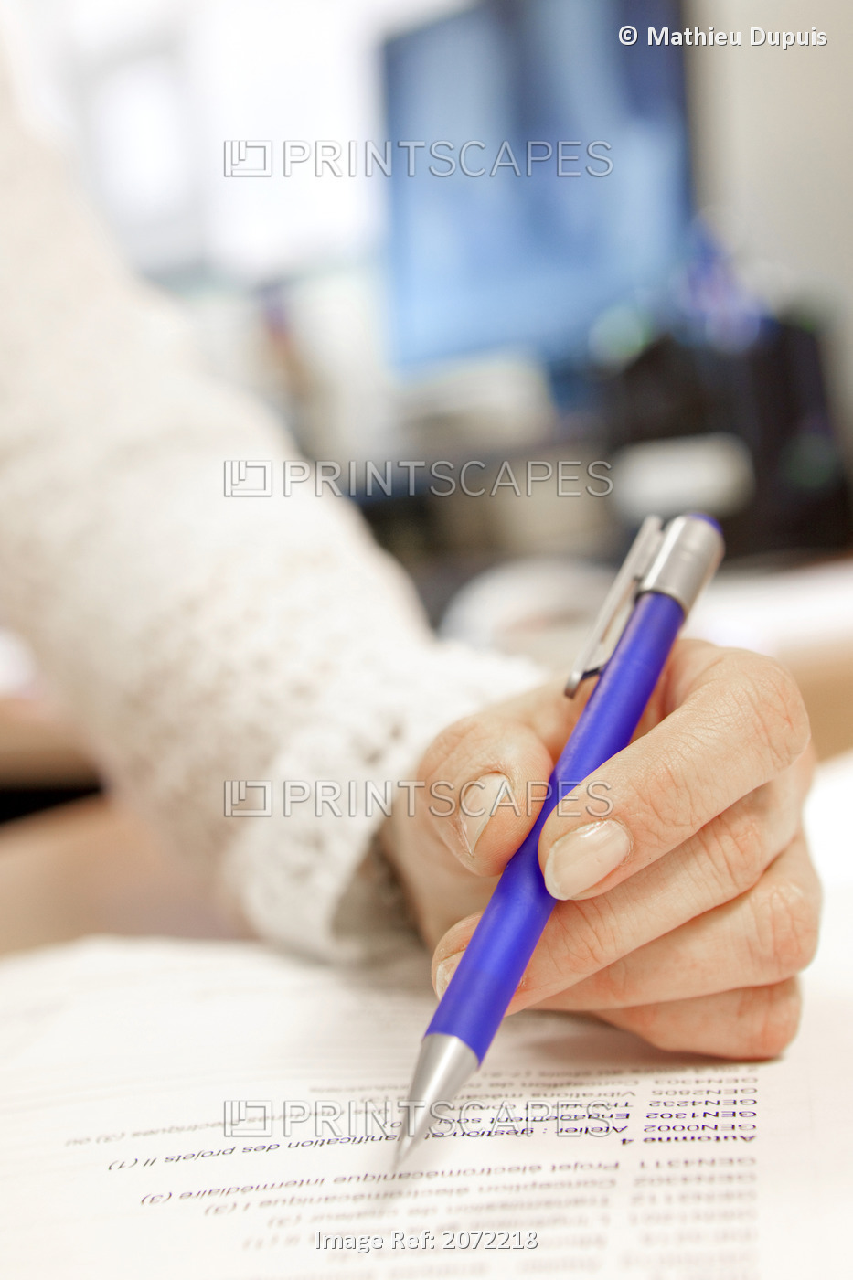 Woman Holding A Pencil Over A Document In An Office
