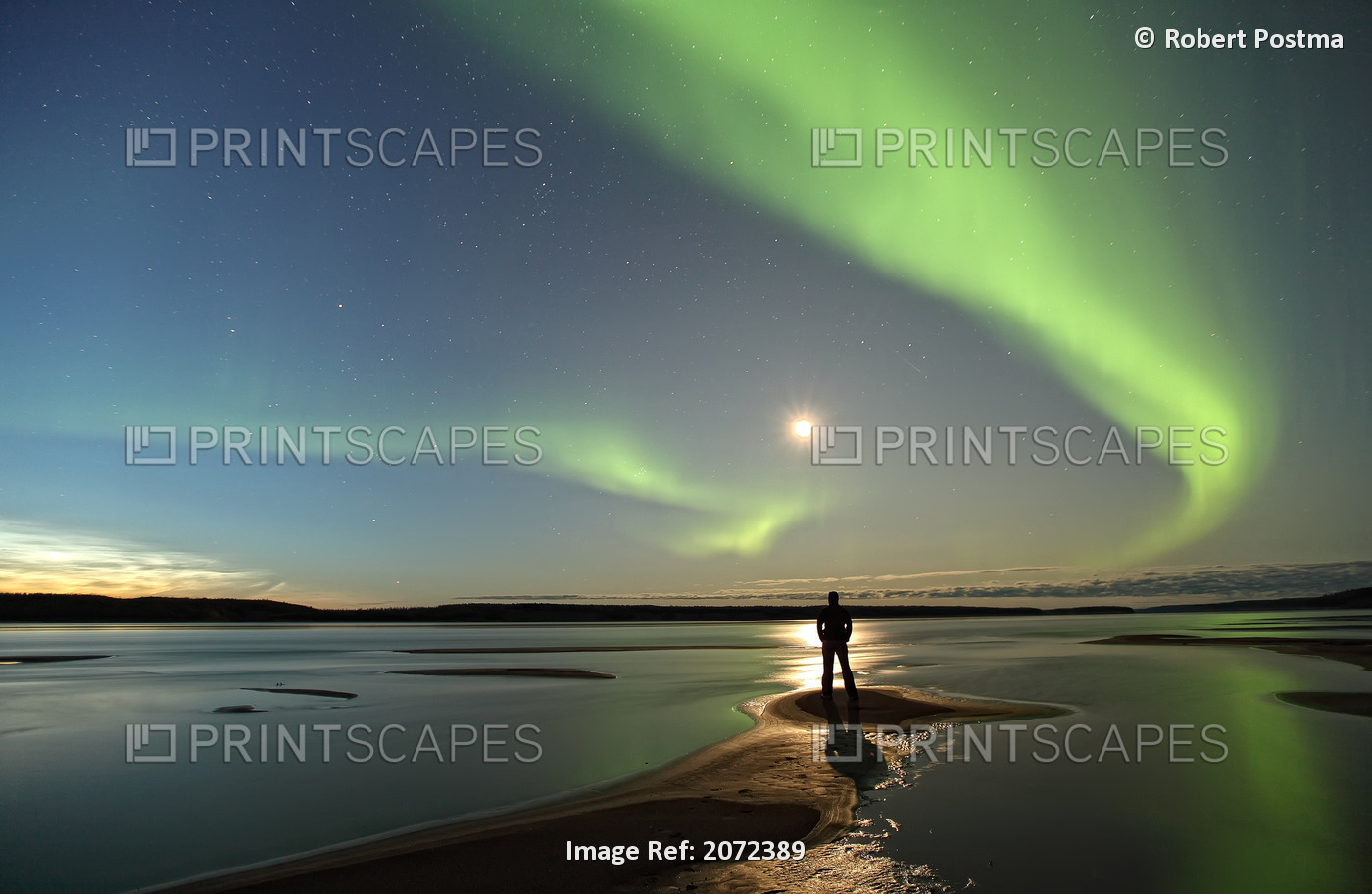 Person Standing Under An Aurora Borealis By The Mackenzie River, Fort Simpson, ...