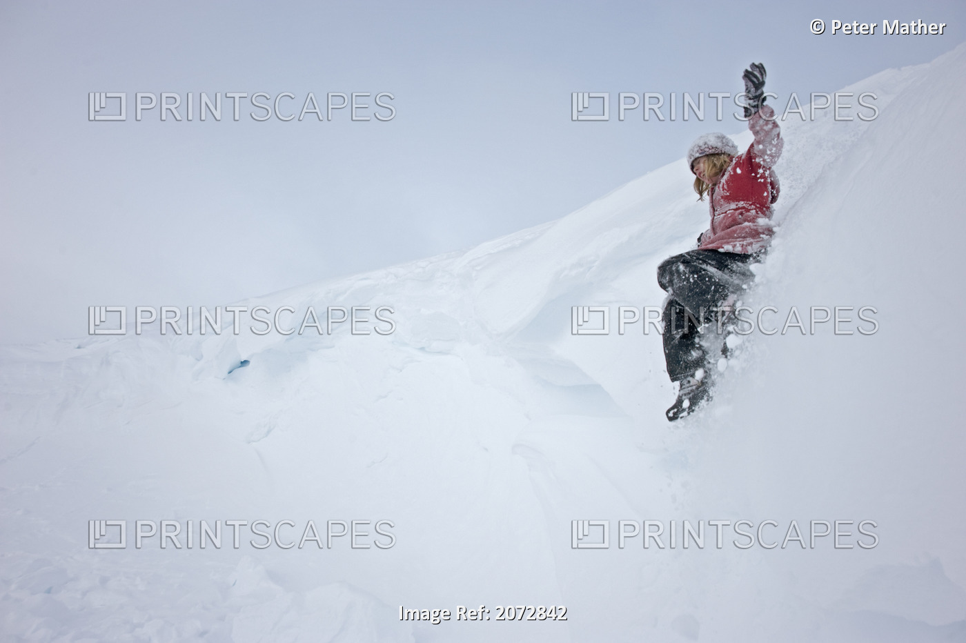 Girl Sliding In Snow, Haines Summit, British Columbia