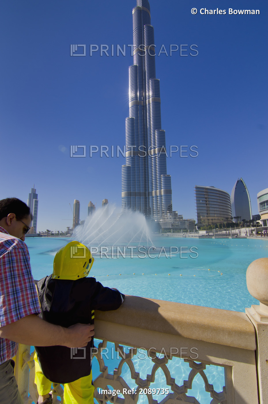 Father And Daughter Standing By Railings At Burj Khalifa, Dubai, Uae