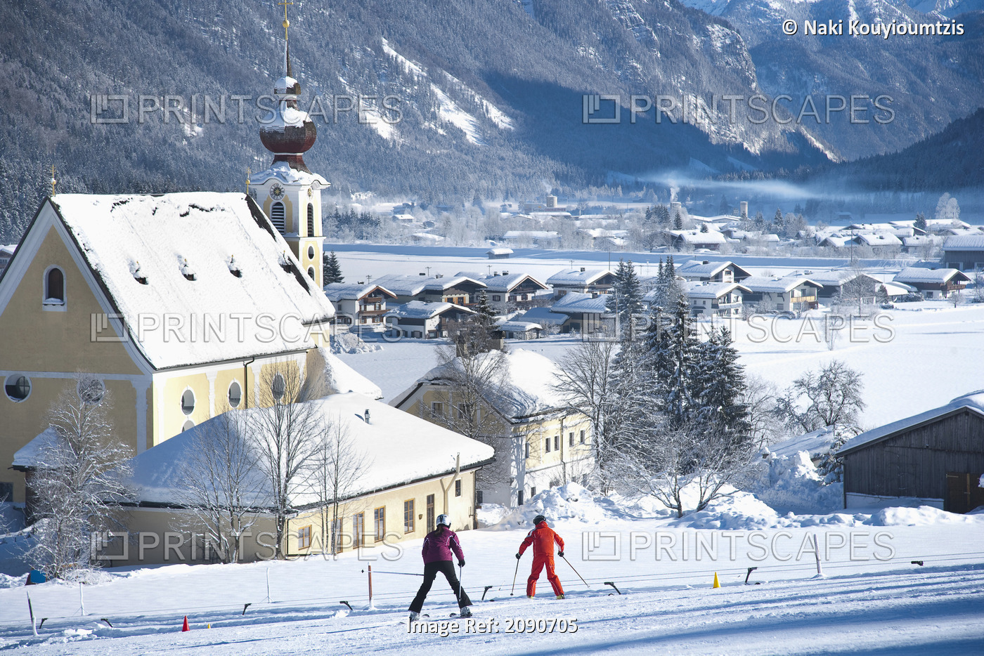 Snow Covered Village With Mountains And Picturesque Church In A Valley Below ...