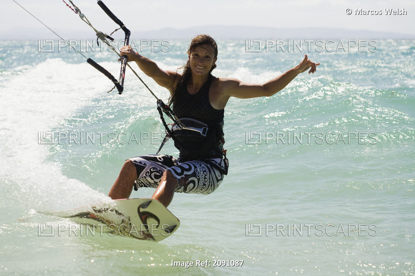 Woman Kitesurfing In Costa De La Luz; Tarifa, Cadiz, Andalucia, Spain