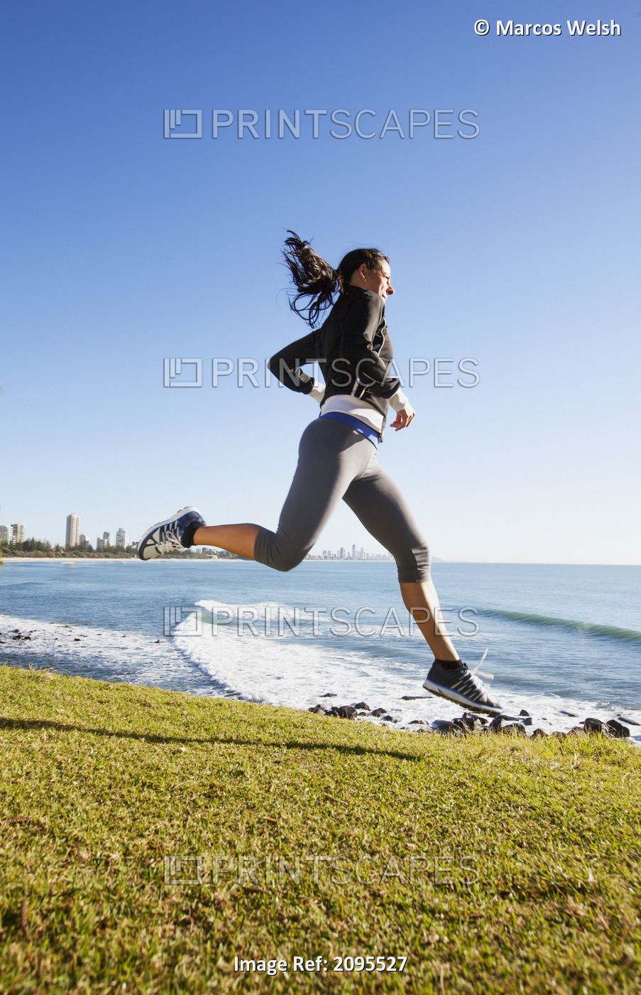 A Young Woman Running By The Water's Edge; Gold Coast Queensland Australia