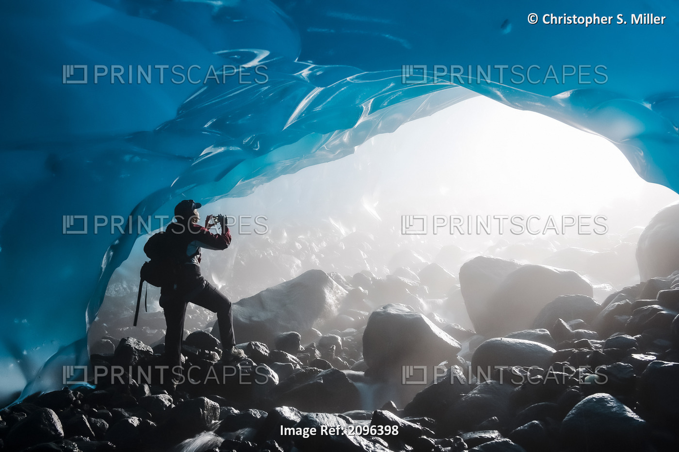 A Hiker Takes A Photograph Of The Entrance Of An Ice Cave From The Inside Of ...