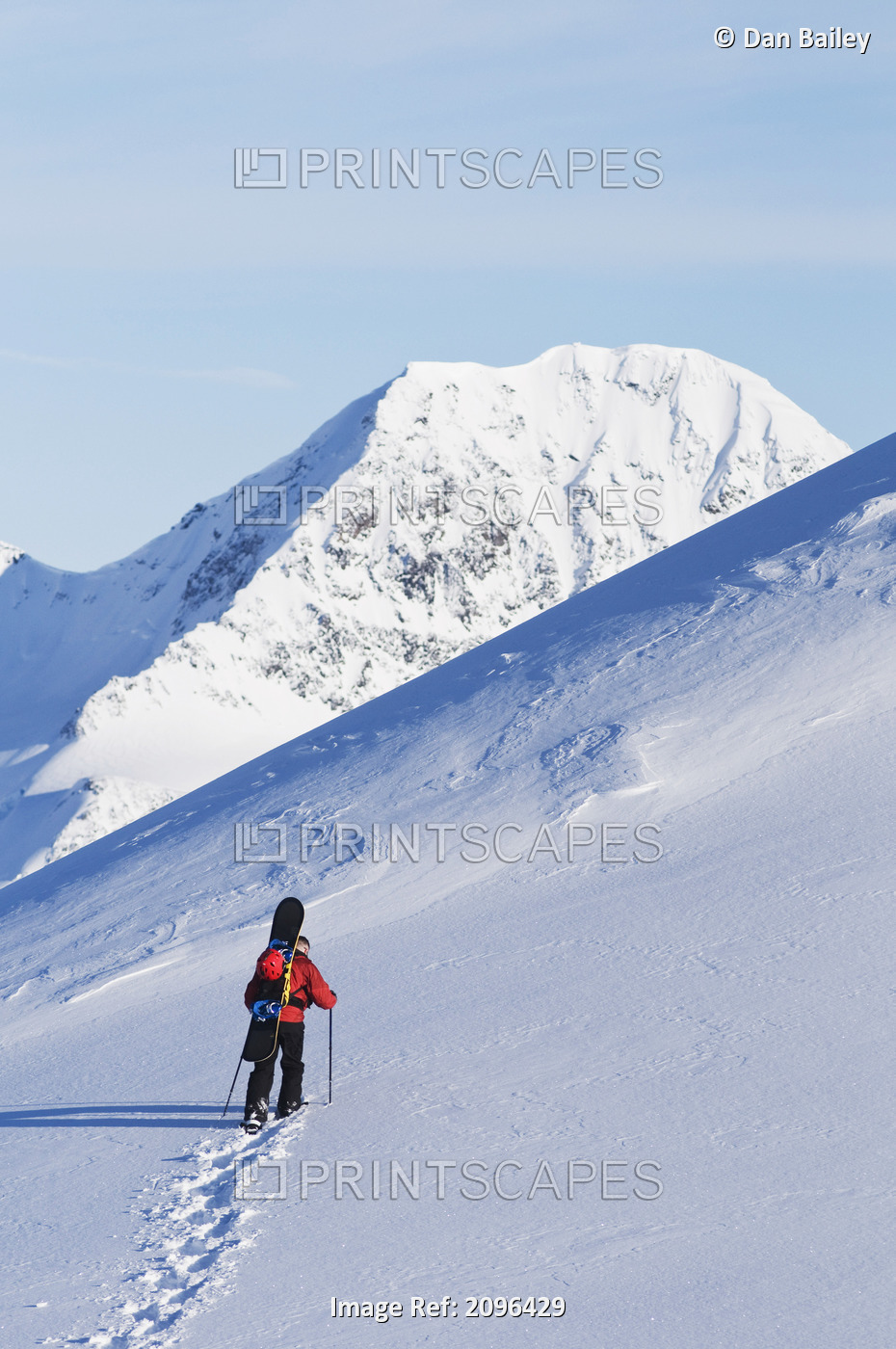 Backcountry Snowboarder Hiking Through The Snow Towards A Mountain Peak, Eagle ...