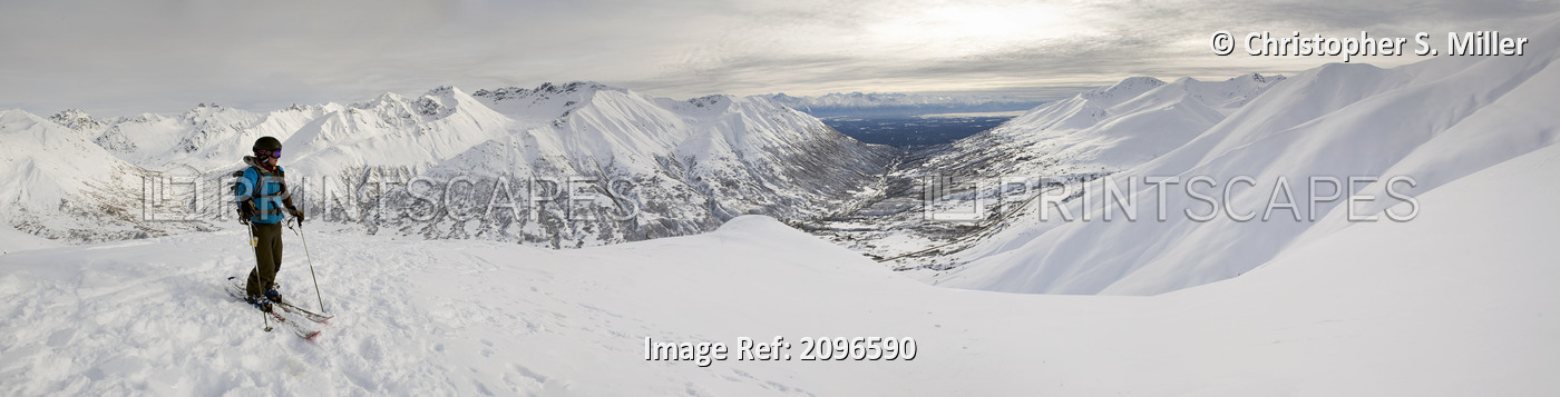 A Backcountry Skier Takes A Moment To Enjoy The View From The Top Of Hatcher ...