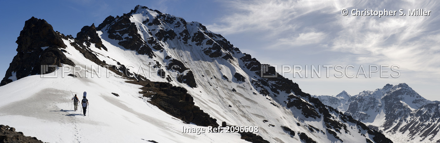 A Backcountry Snowboarder And Skier Hike Up The West Ridge Of Powerline Pass ...