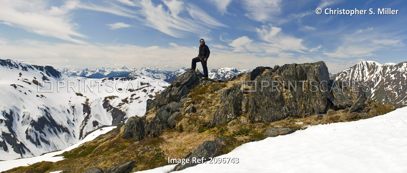 A Snowboarder Takes A Moment To Enjoy The View While Heliskiing Near Juneau, ...