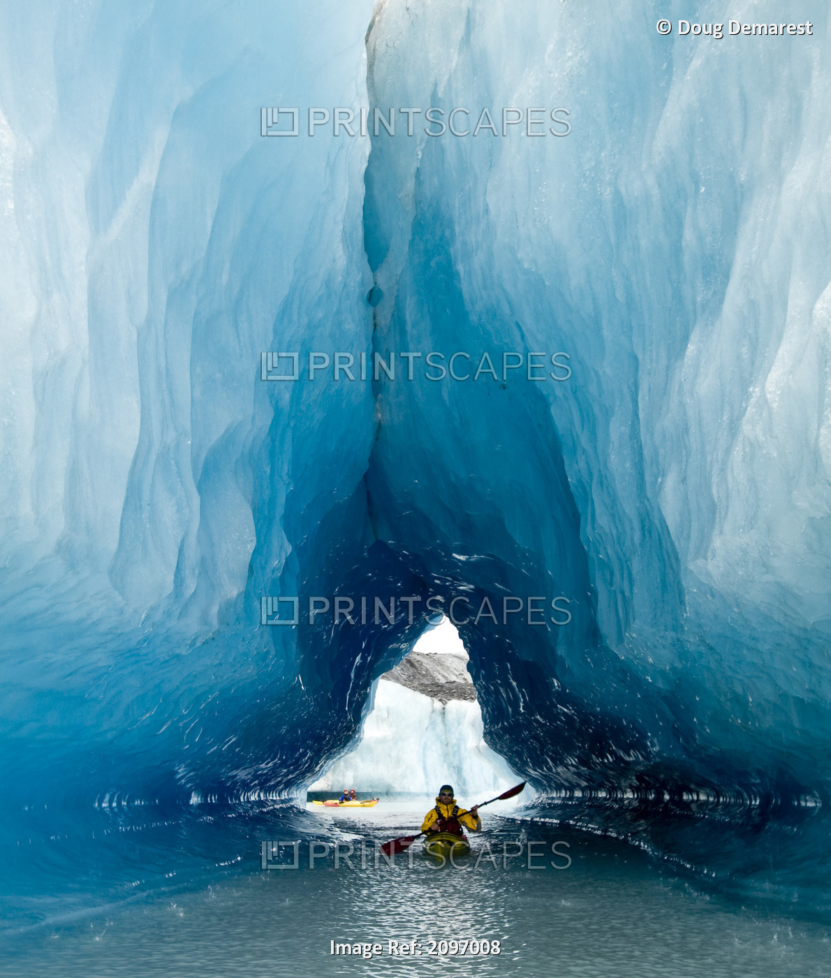 Sea Kayaker Paddles Through An Ice Cave Amongst Giant Icebergs Near Bear ...