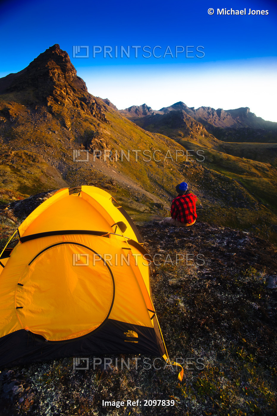 A Man Standing On A Rock Next To His Tent While Camping Near Hatcher Pass In ...