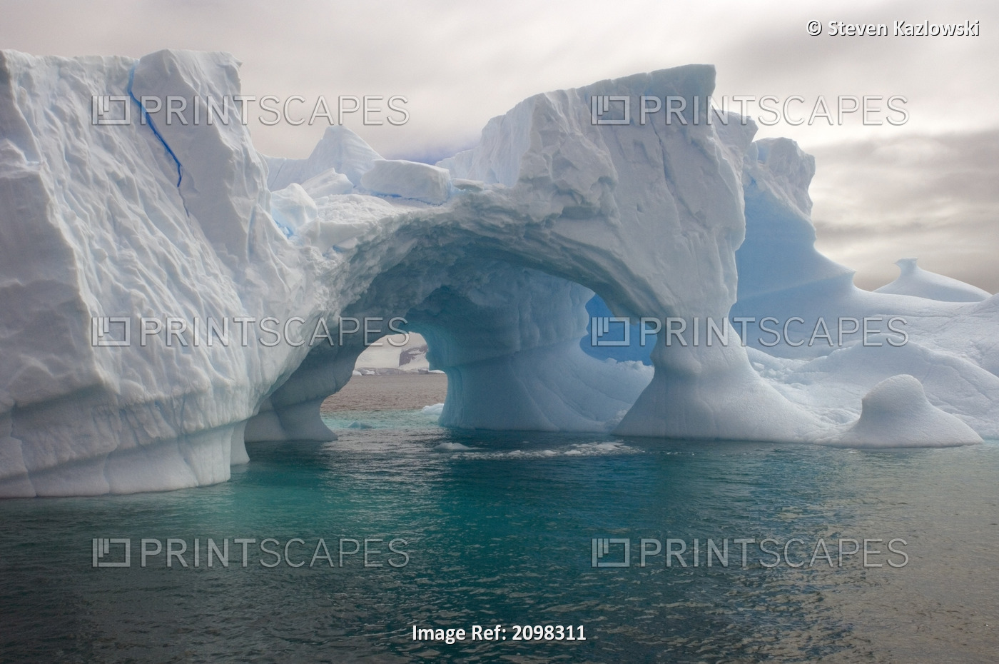 Arched Iceberg Floating Off The Western Antarctic Peninsula In The Southern ...