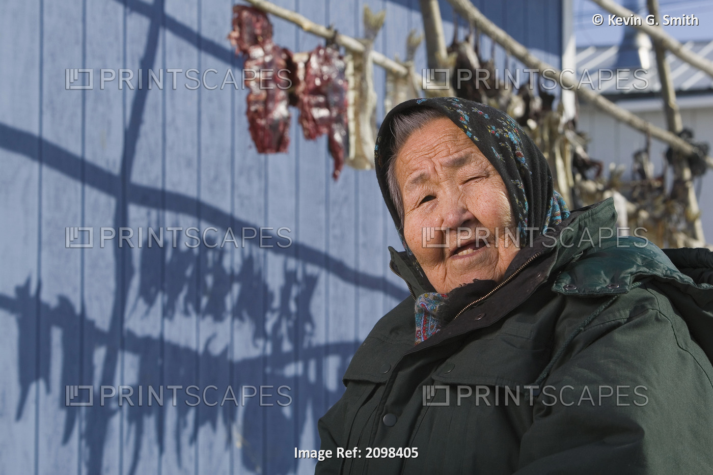 Portrait Of Elder Female Yupik Woman Sitting Outside Her House Near Fish Drying ...
