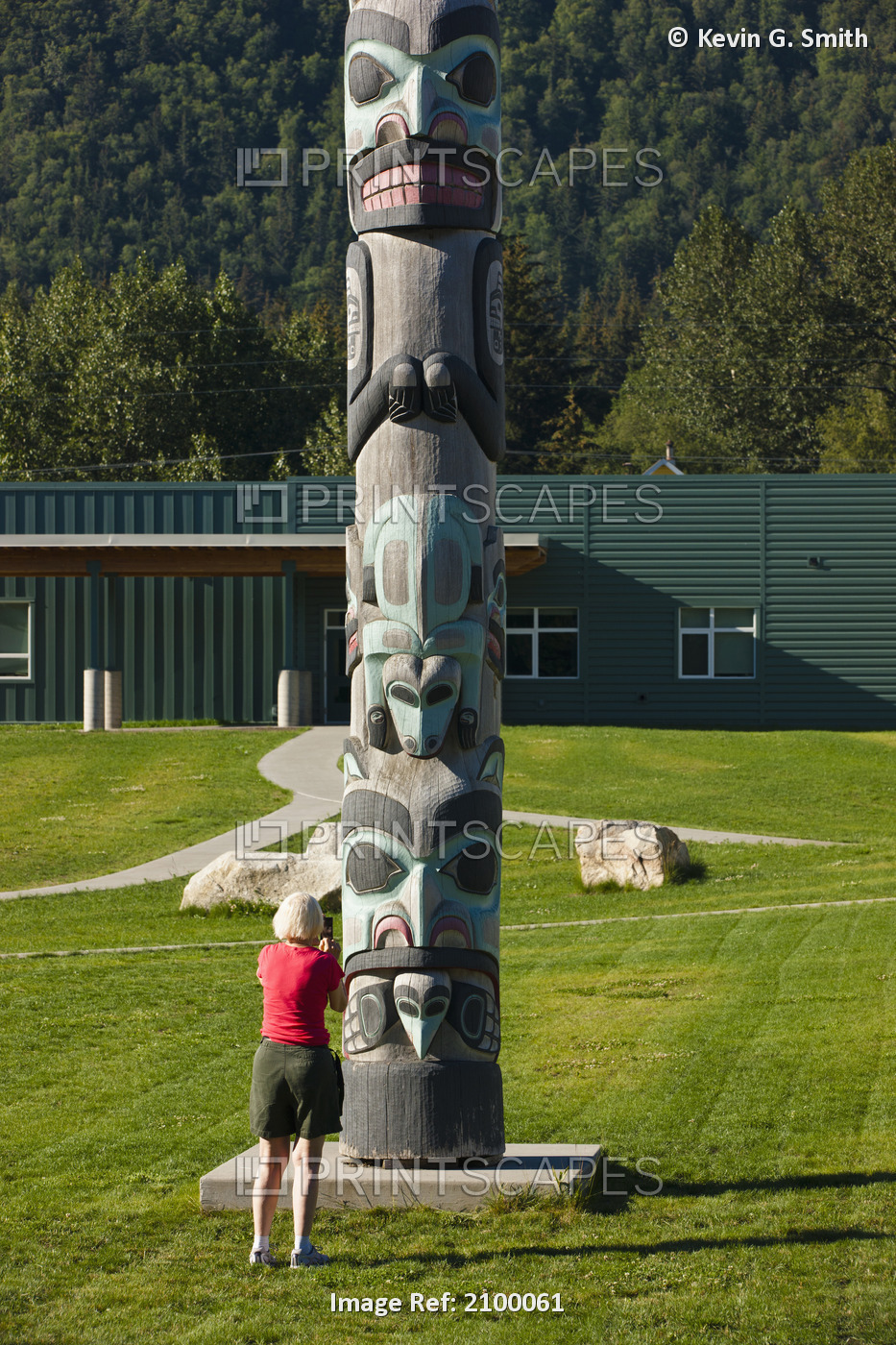 Tourist Taking A Photo Of The Tlinget Totem Pole At The Haines Public School, ...