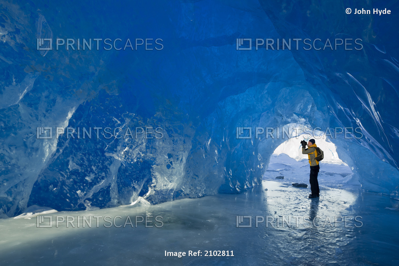 Man Photographs Inside An Ice Cave Of An Iceberg Frozen In Mendenhall Lake, ...