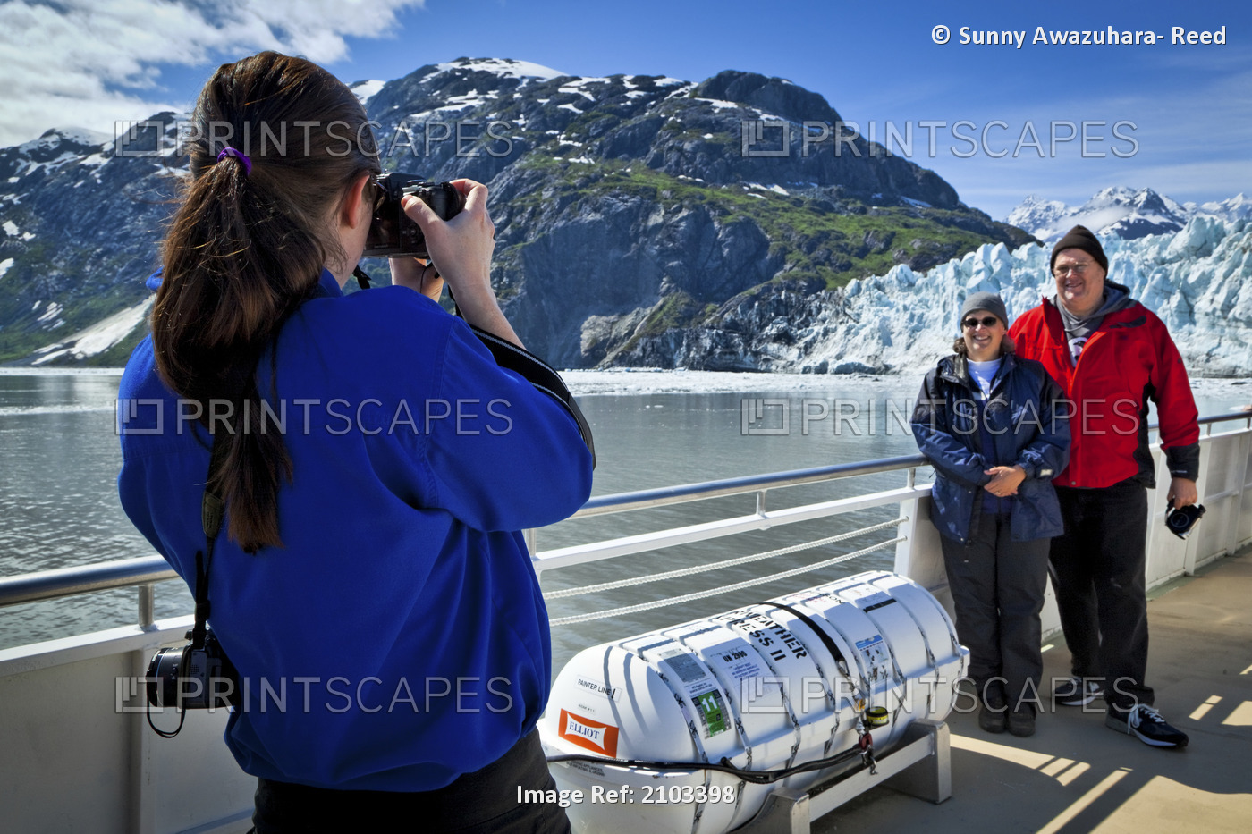 A Boat Crew Member On A Tour Boat Taking Pictures Of A Couple In Front Of ...