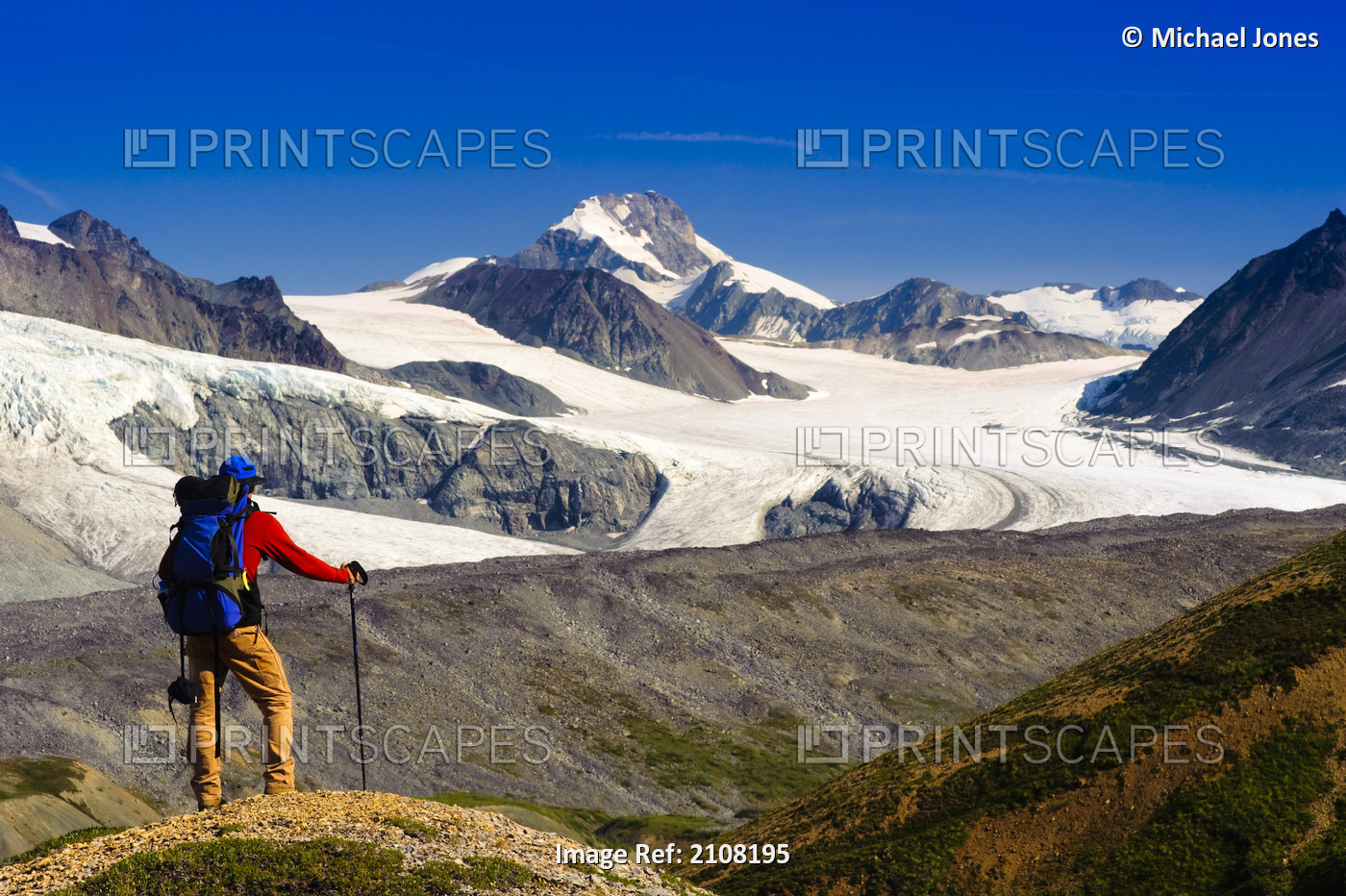 Male Backpacker Stops To View Gulkana Glacier While Hiking In The Alaska Range, ...
