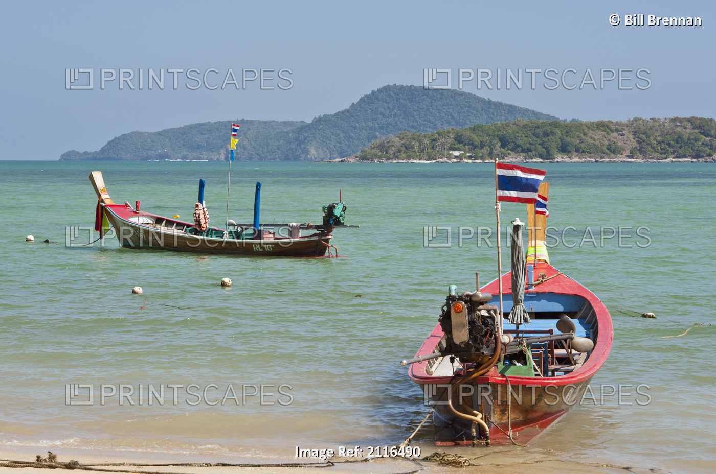Thailand, Phuket, Rawaii Beach, Longtail boats along the shoreline, Land in ...