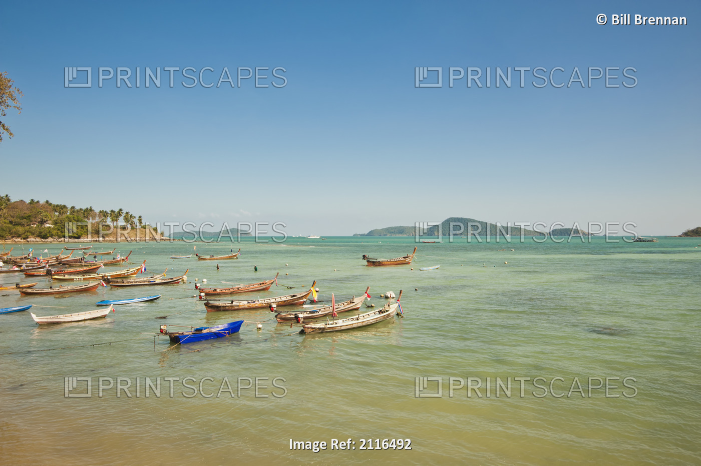 Thailand, Phuket, Rawaii Beach, Longtail boats along the shoreline, Land in ...