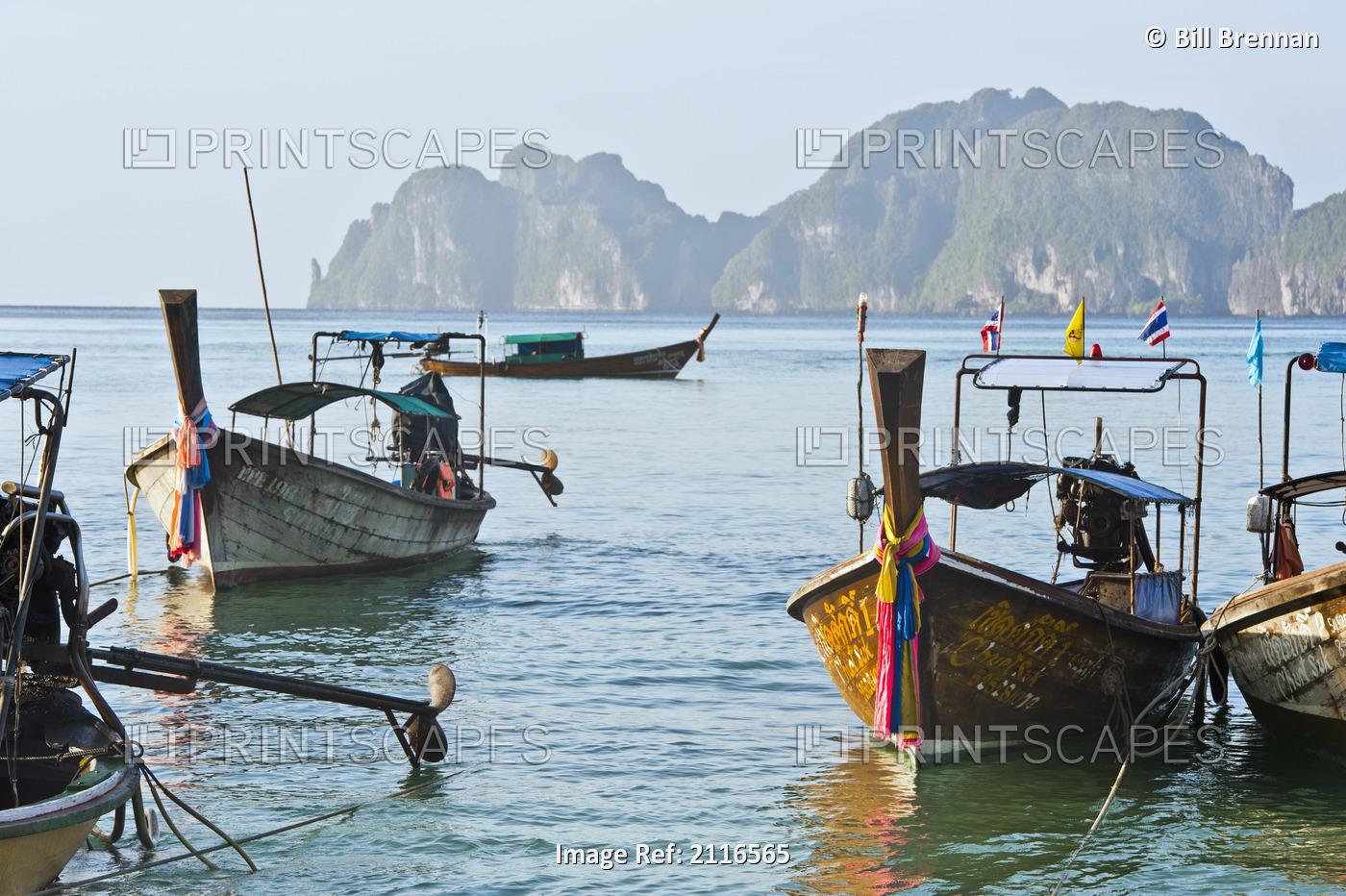 Thailand, Koh Phi Phi, Longtail boats along the shoreline, Mountains in ...