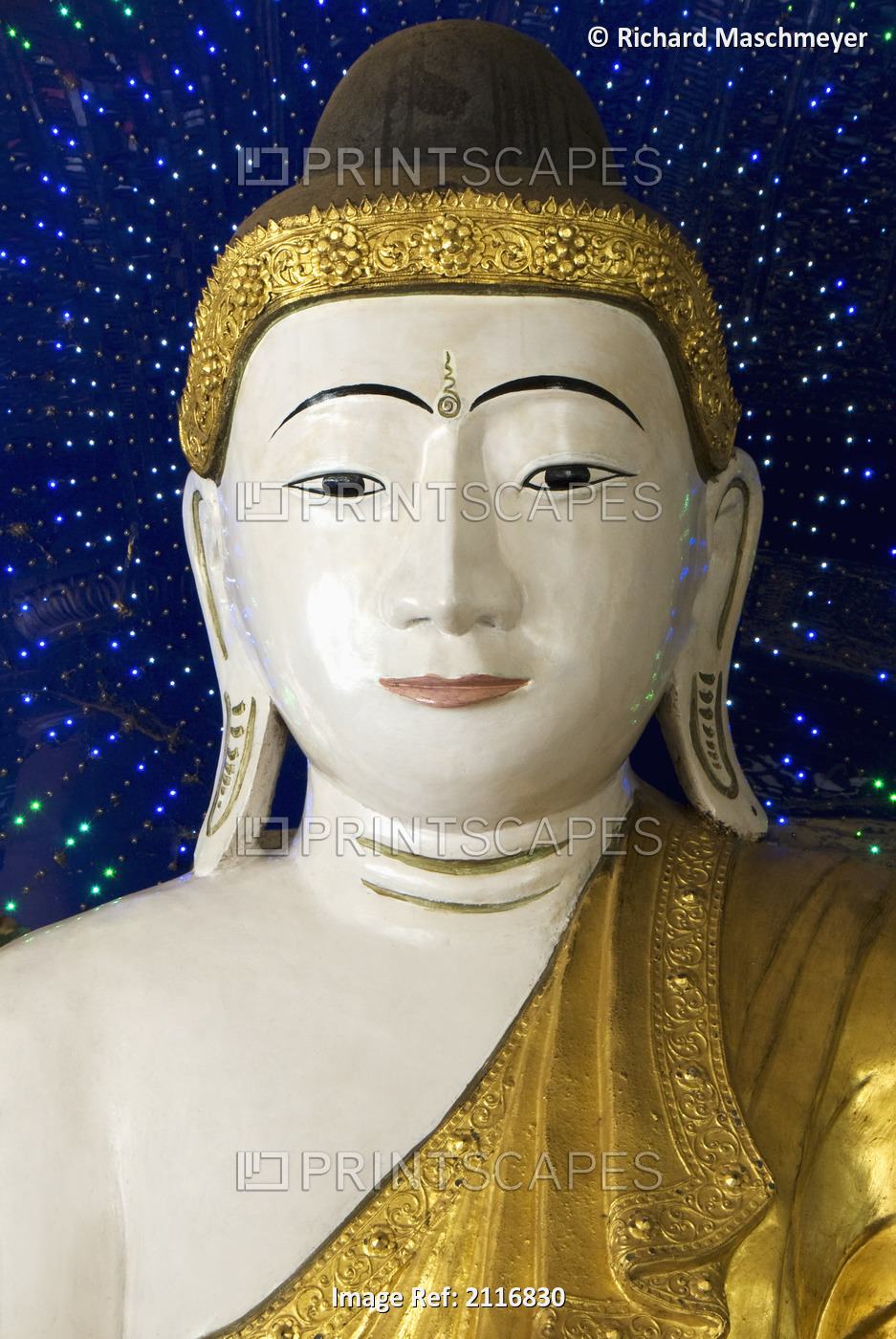 Myanmar, Yangon, Shwedagon, Paya, Head of a Buddha statue against blue ...