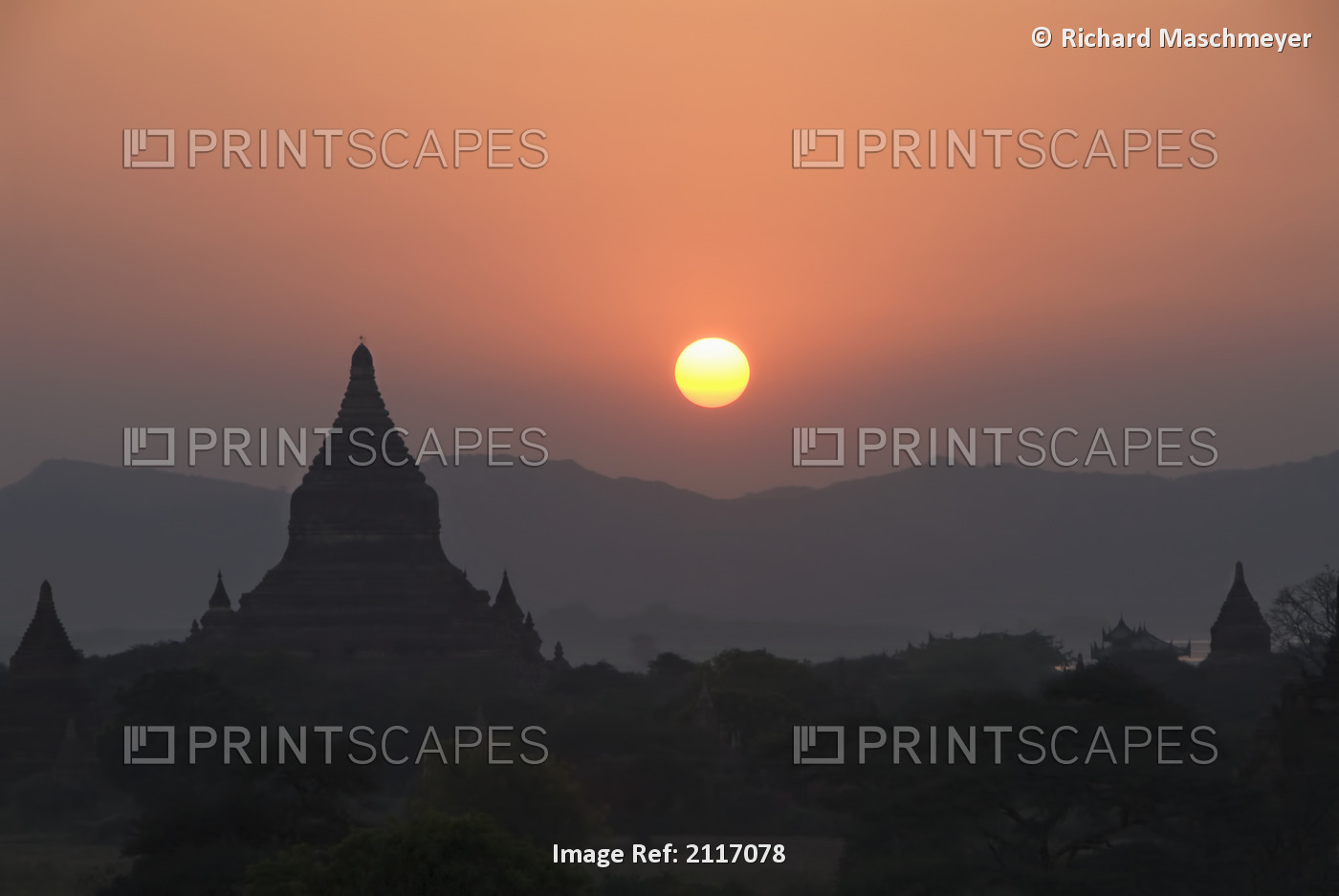 Burma (Myanmar), Bagan, Silhouetted temples and sunball at sunset.