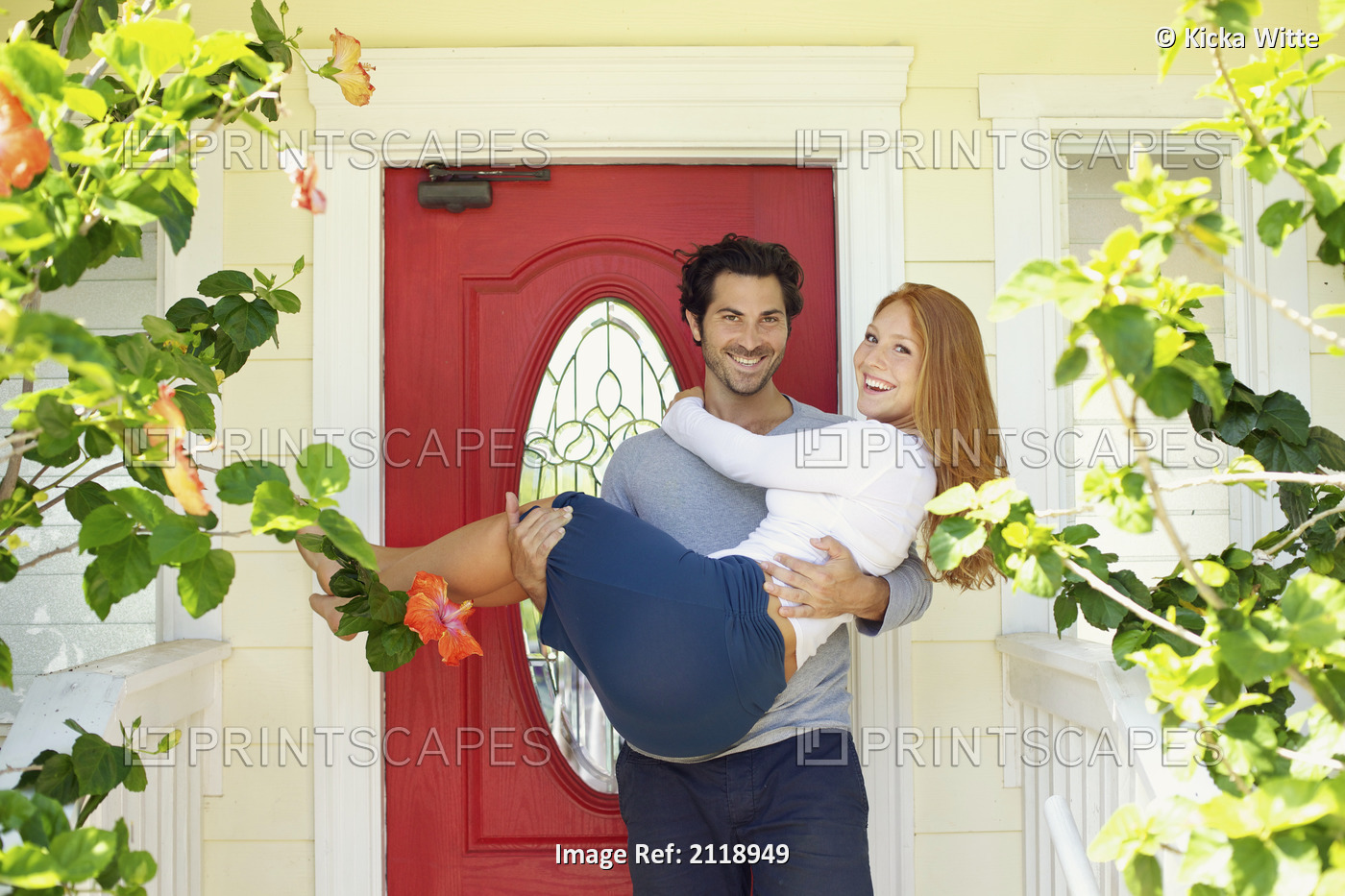 A man holds a woman at the front door of their home; Wailua kauai hawaii united ...