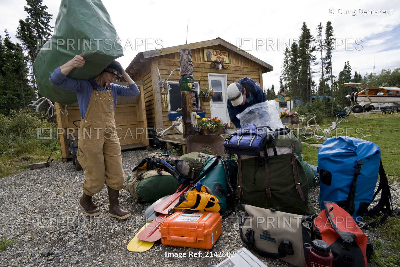 Two People Prepare For An Air Charter Flight Out Of Coldfoot. Summer In Arctic ...