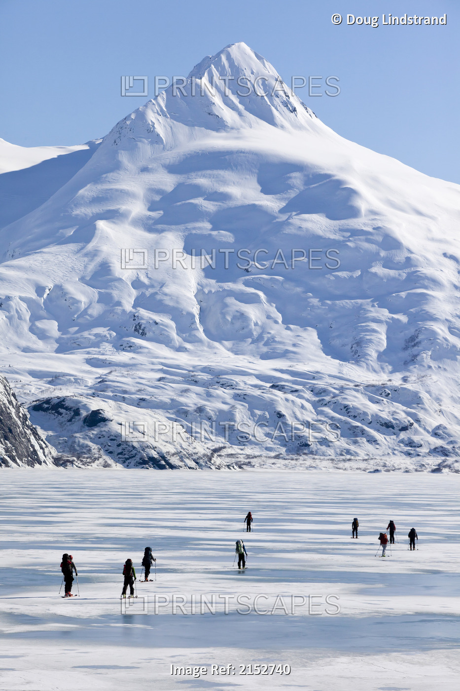 A Group Of Skiers Ski Across Frozen Portage Lake With Mount Bard In The ...