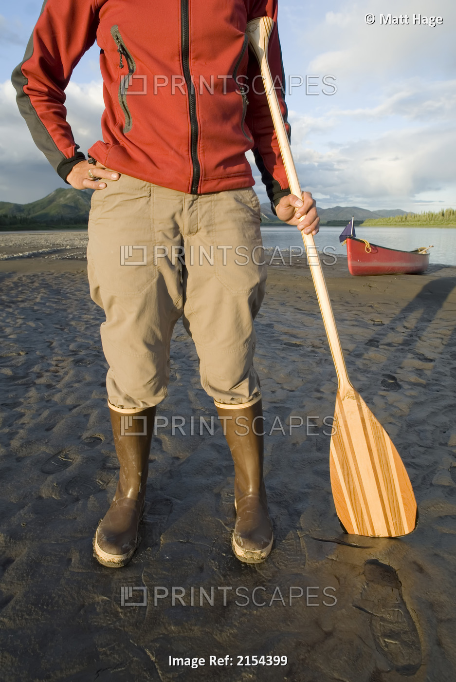 Close-Up Of Woman Holding A Canoe Paddle, Standing On The Bank Of The Yukon ...