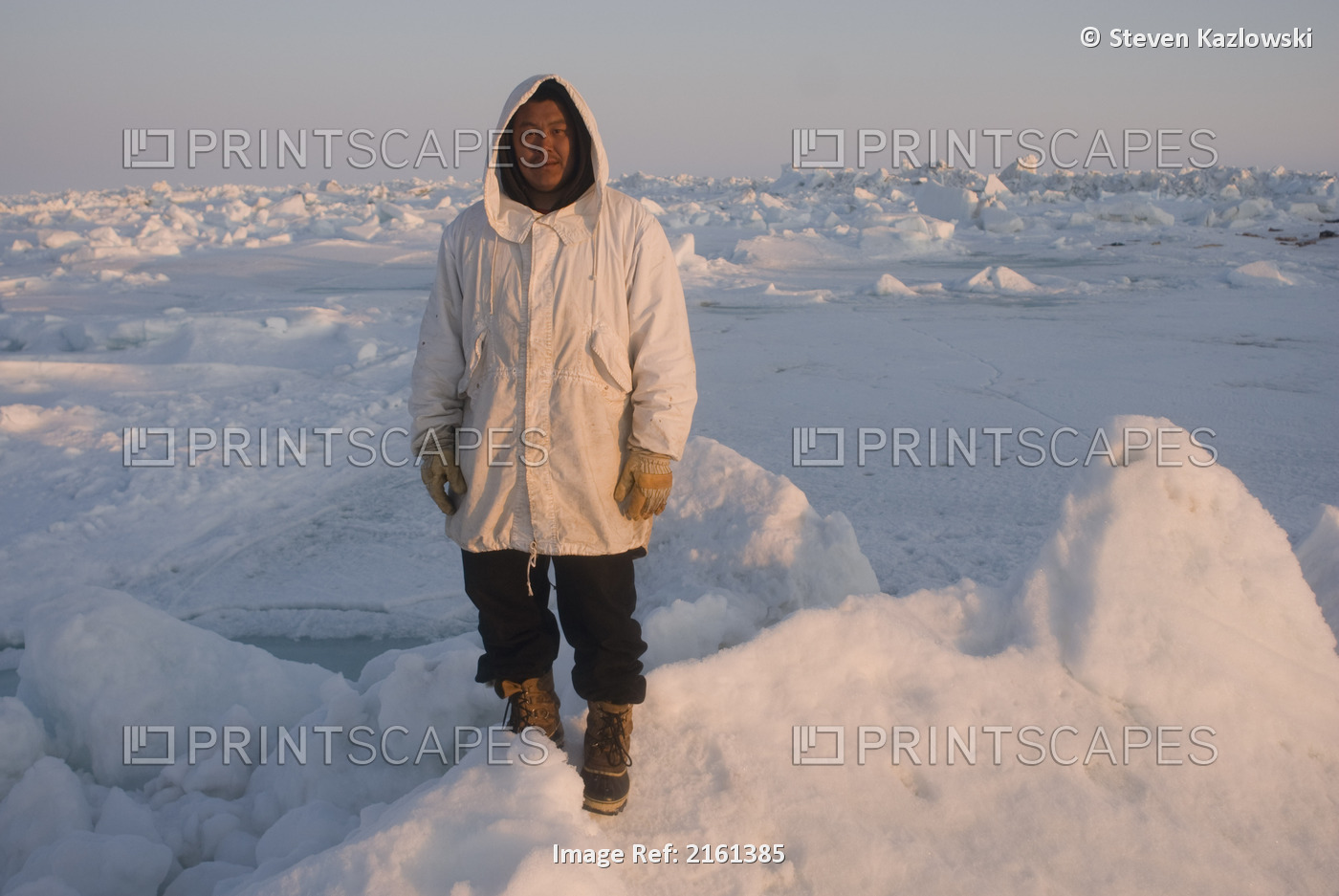 An Inupiaq Subsistence Hunter Stands At The Ice Edge Of Unstable Ice During A ...