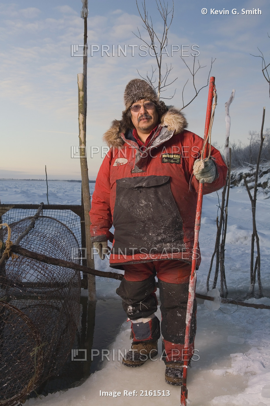 Elder Yupik Eskimo Man Standing Next To Lush Fish Trap On Frozen Kuskokwim ...