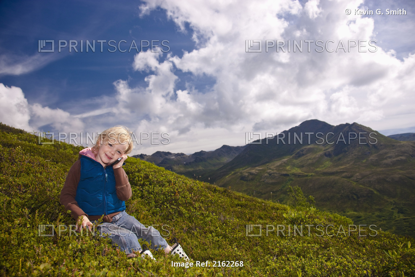 Young Girl Talking On A Cell Phone On A Hillside In Hatcher Pass, Southcentral ...