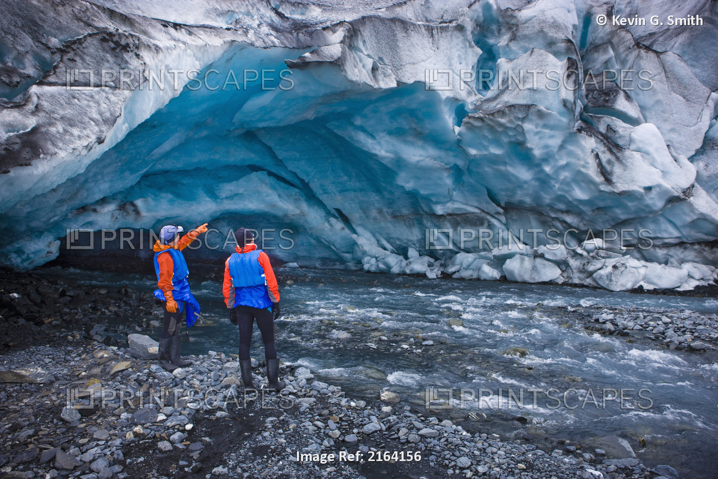 Male & Female Kayakers Explore An Ice Cave In Front Of Shoup Glacier, Shoup Bay ...