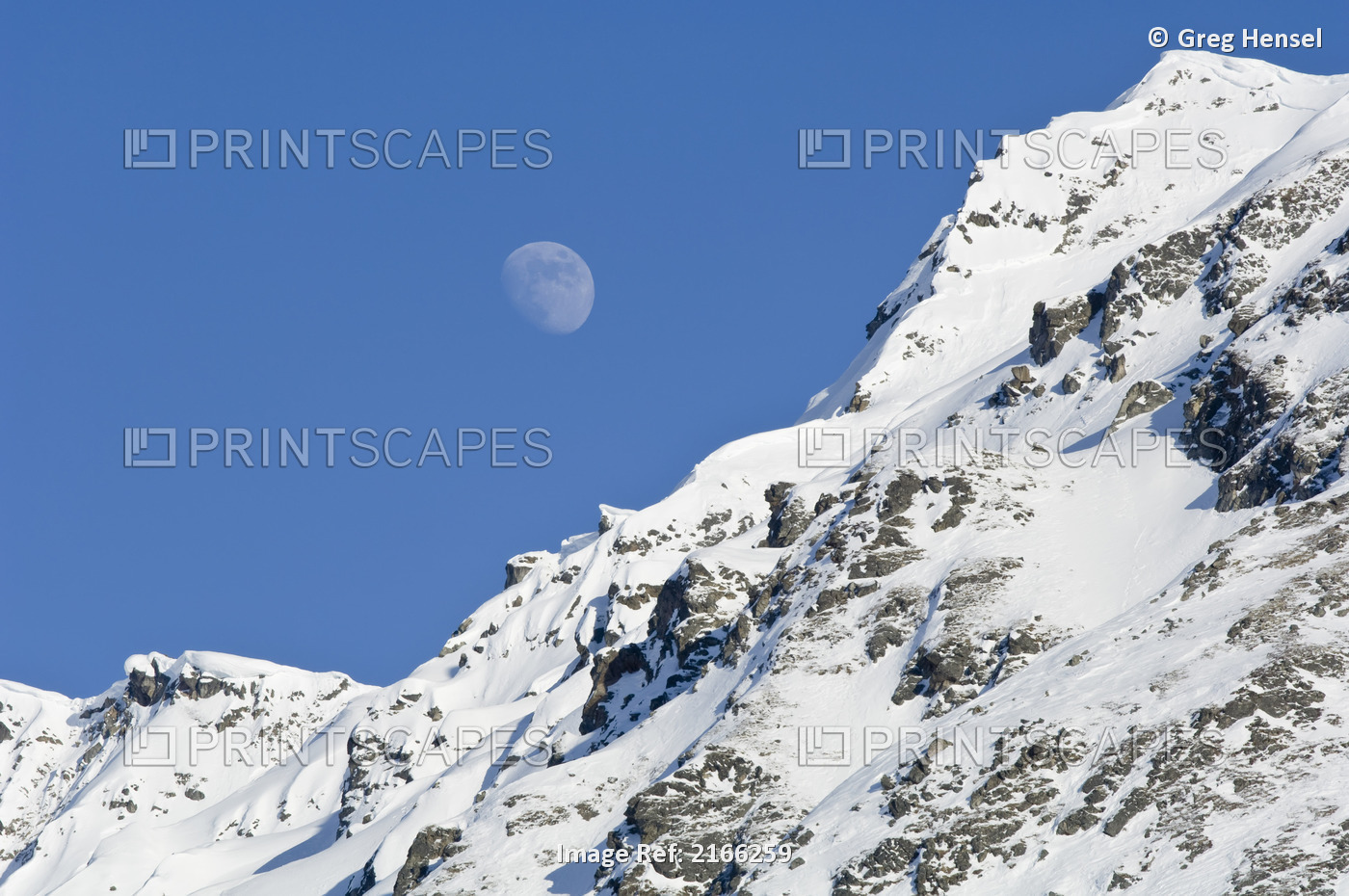 Moon Rising Over Snow Covered Mountain Peak At Hatcher Pass In Southcentral ...