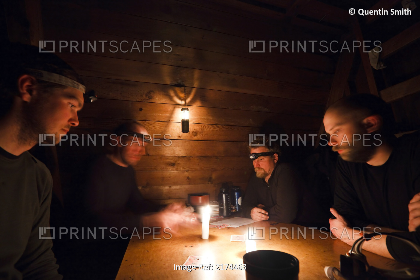 Four Men Play Cribbage By Candle Light In The Forest Service's Rynda Cabin Near ...