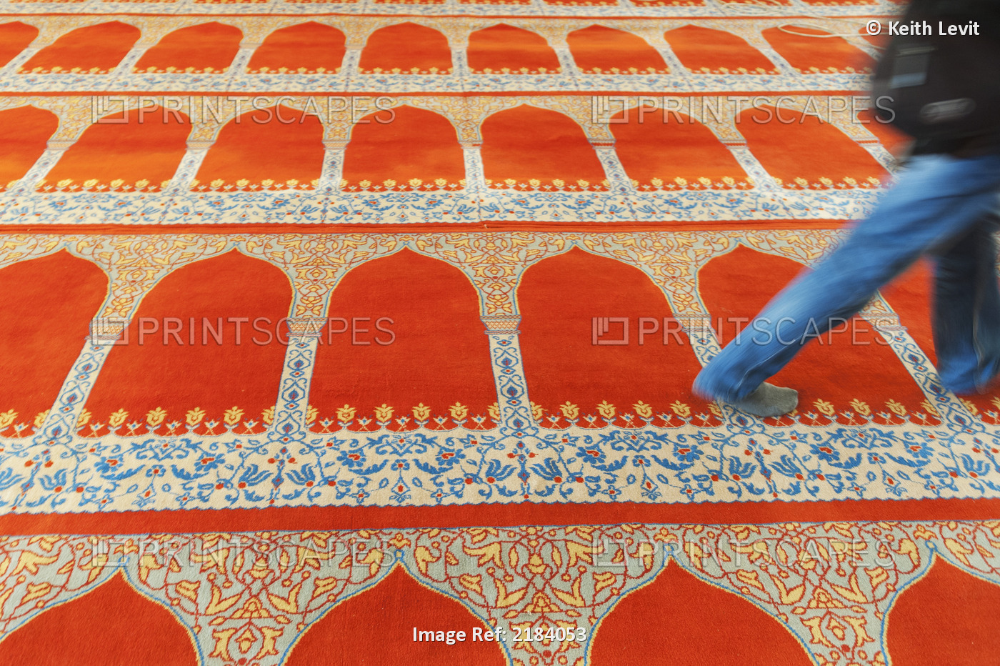 A person walking over the colourful carpet in the suleymaniye mosque;Istanbul ...