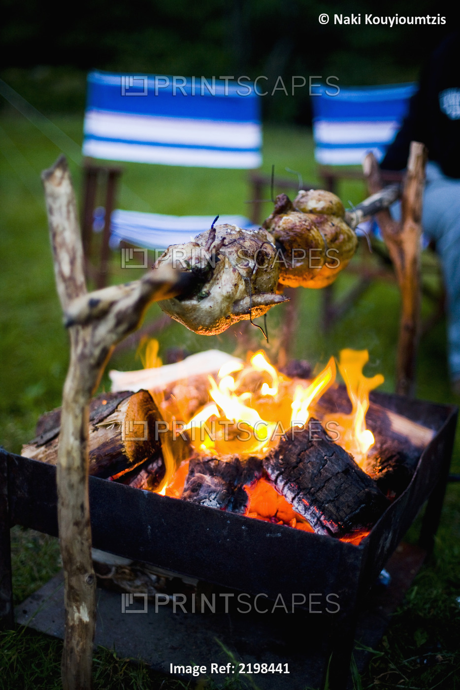 UK, Wales, North Wales, Snowdonia National Park, Spit roast chicken over open ...