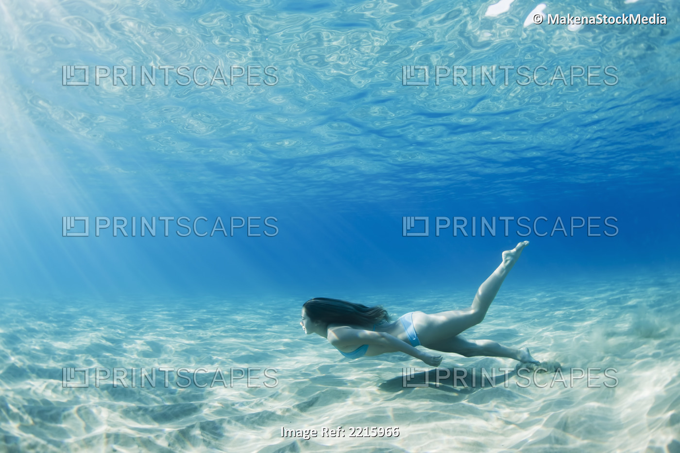 Hawaii, Maui, Makena, Young woman swimming along the ocean floor.
