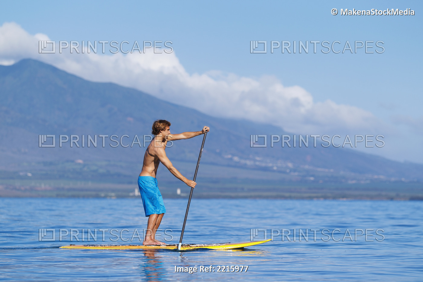 Hawaii, Maui, Kihei, Young man Stand Up Paddling in the ocean on sunny day.