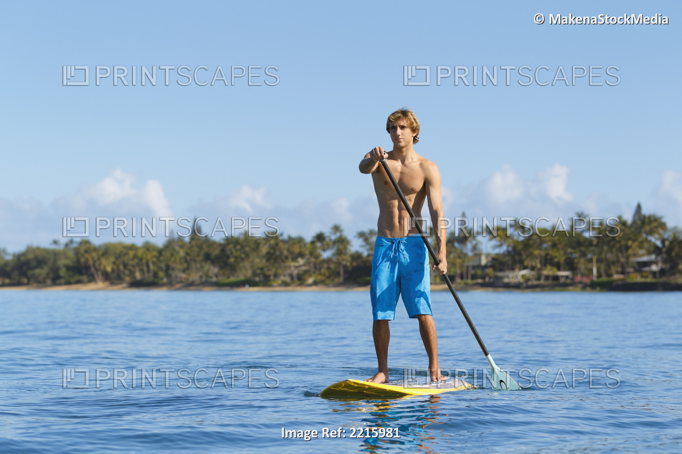Hawaii, Maui, Kihei, Young man Stand Up Paddling in the ocean on sunny day.