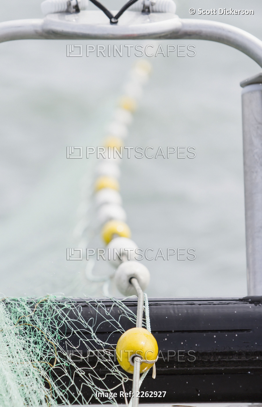 The yellow and white corks of a drift gillnet extend across the bow roller as ...
