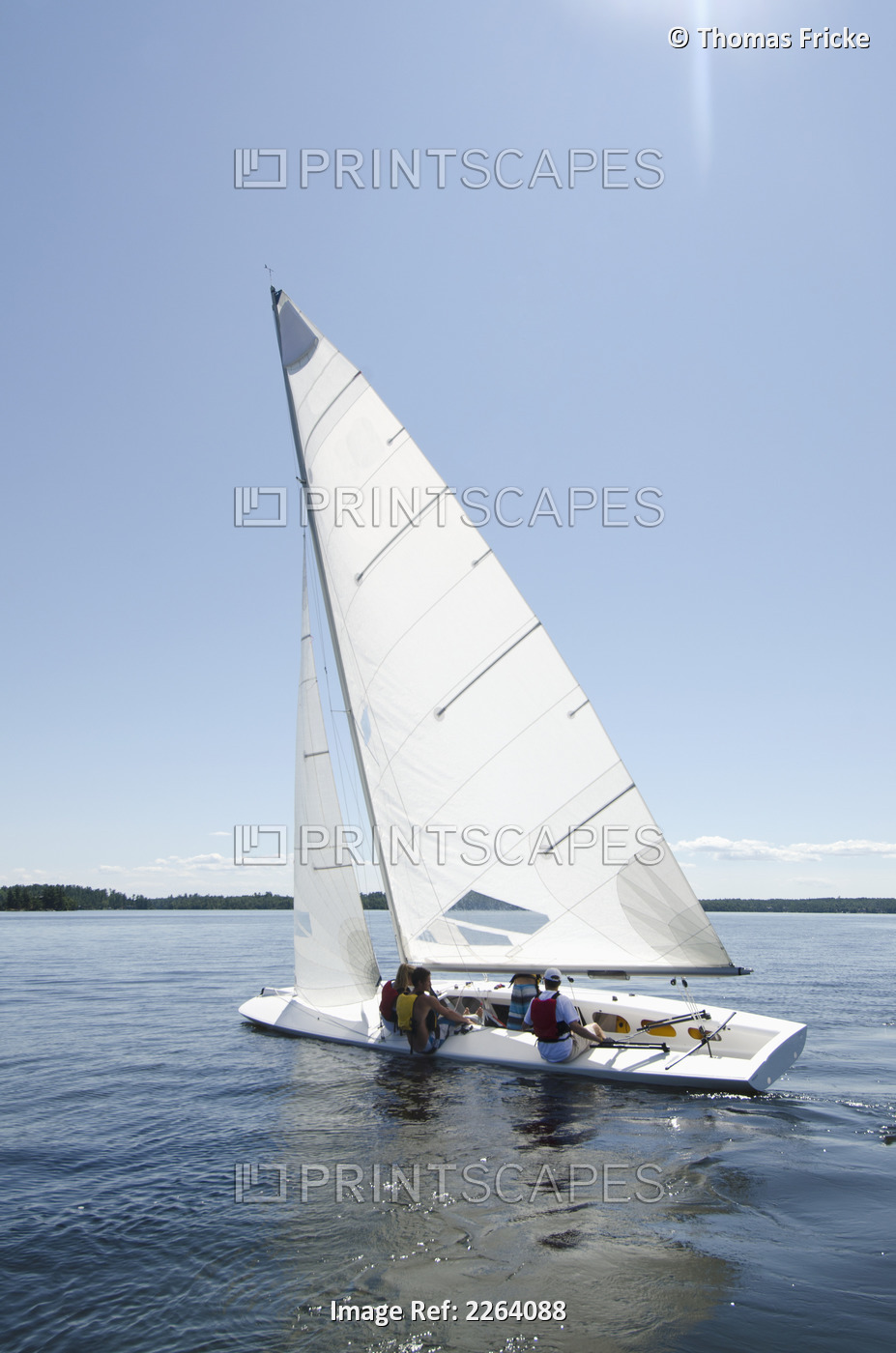 Sailboat With Crew Sailing On A Lake; Kenora Ontario Canada