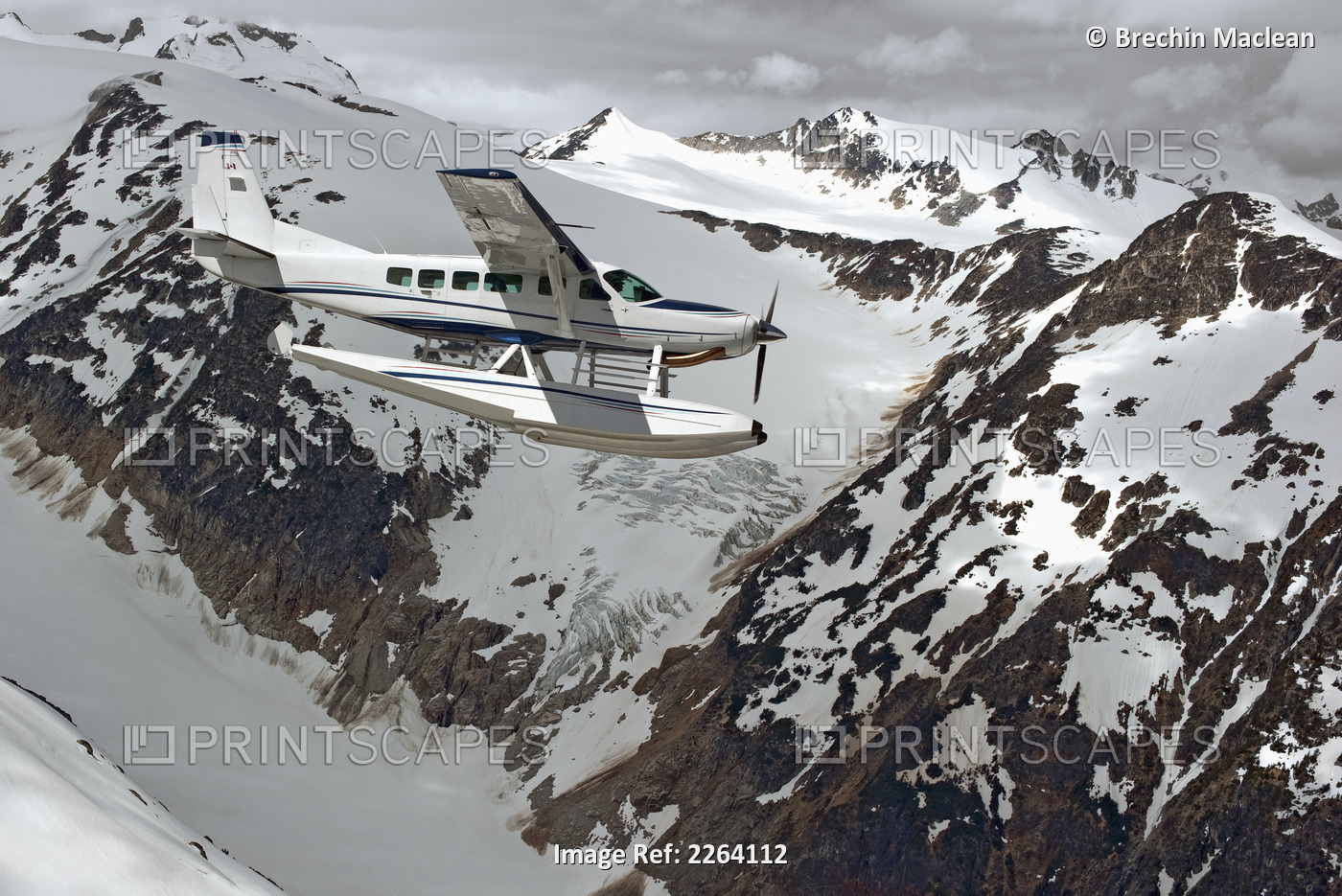 Cessna Caravan Amphibian Seaplane Flying Through The Coast Mountains; British ...