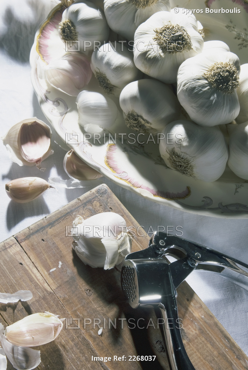 Cloves of garlic with a press