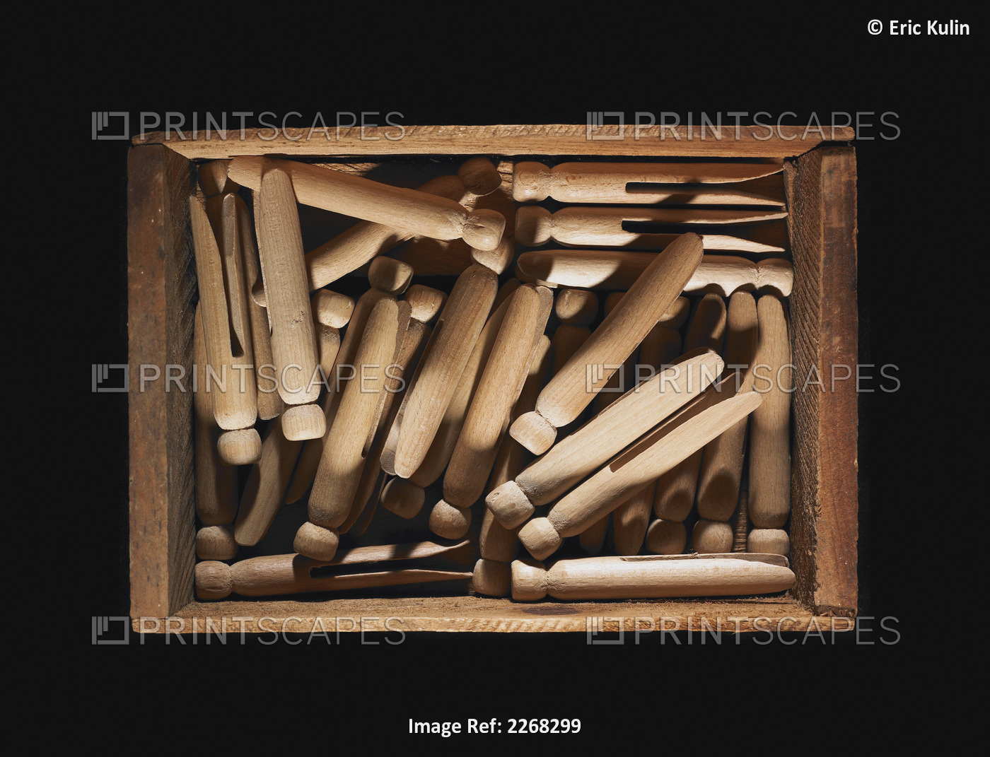 Clothes pins in a wooden crate