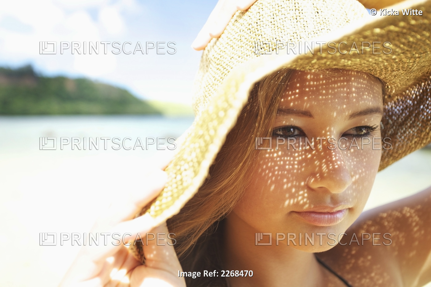 Portrait of a young woman wearing a sunhat; Kauai hawaii united states of ...