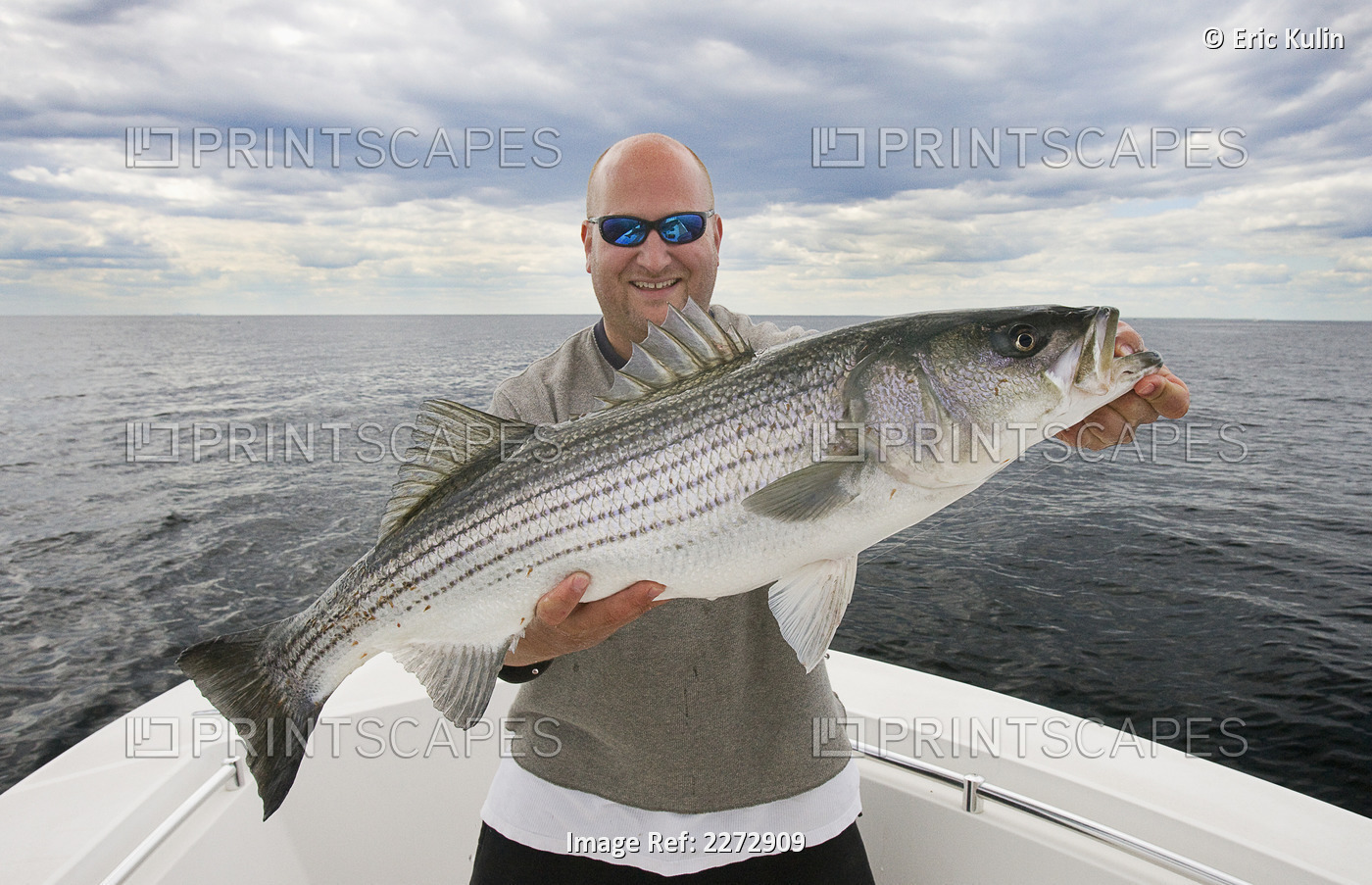 Man In A Boat Proudly Holding A Large Fish; Usa