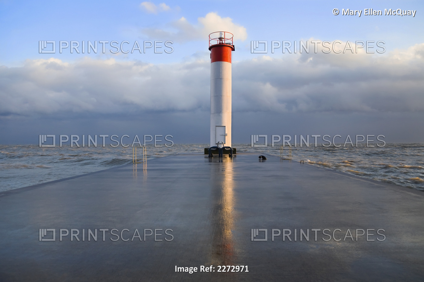 Lighthouse reflected on a wet pier on a stormy day by lake ontario; whitby ...