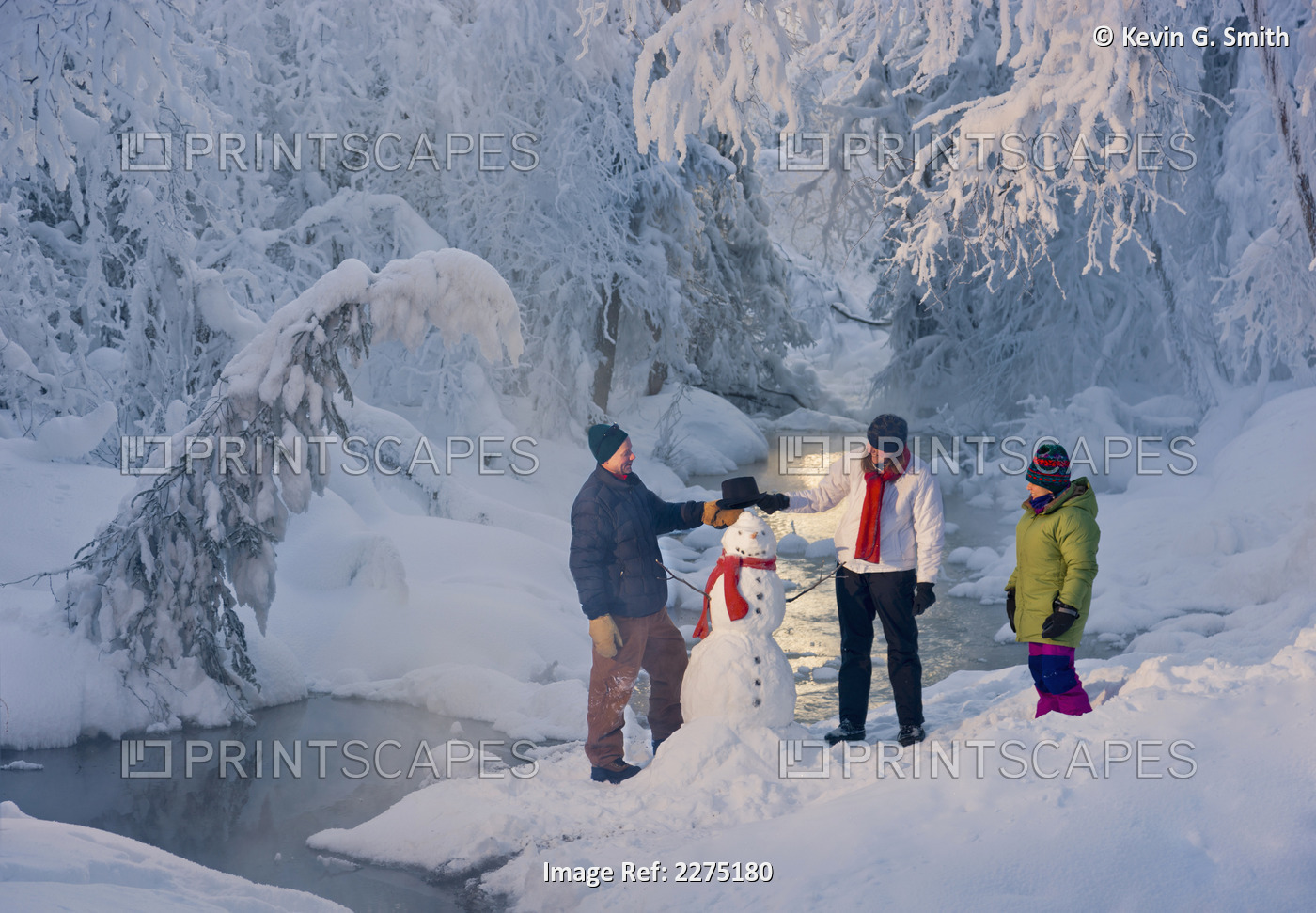 Family Stands Next To A Snowman Next To A Small Stream In A Hoarfrost Covered ...
