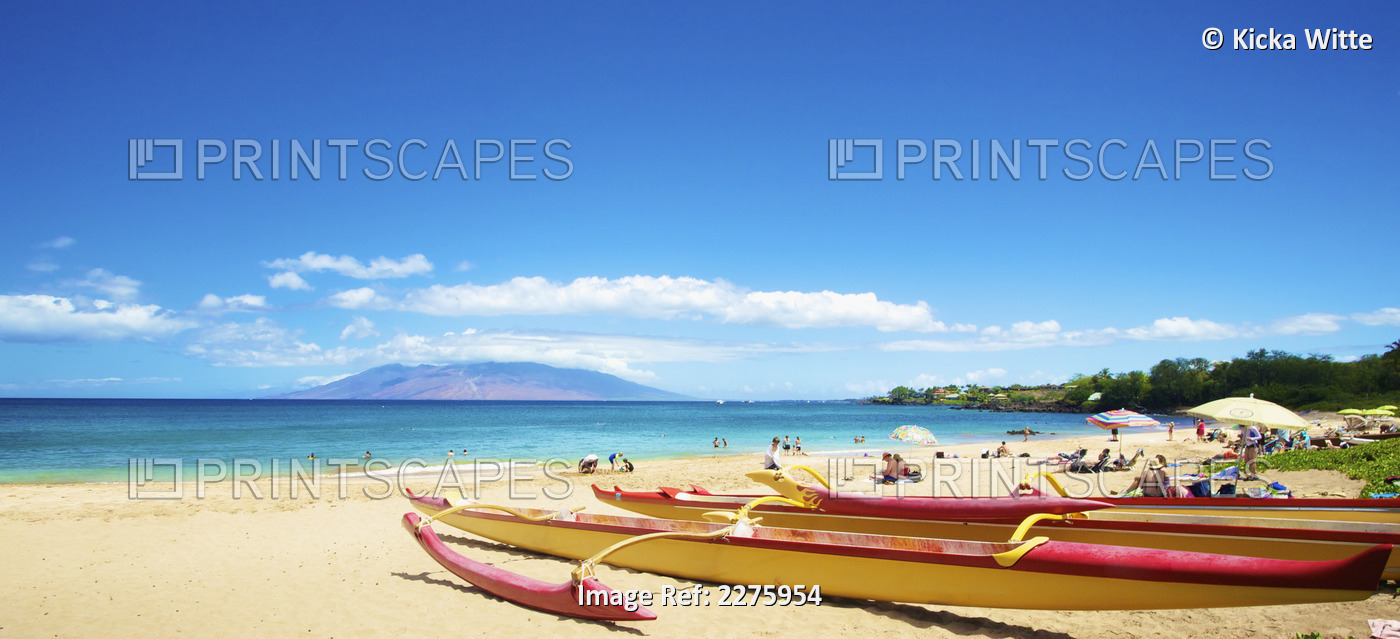 A Beach With Sunbathers And A Boat; Hawaii, United States Of America